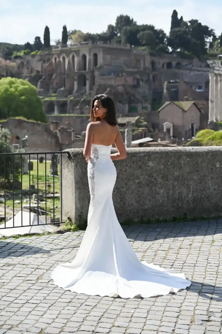 model is wearing a strapless fit and flare bridal gown