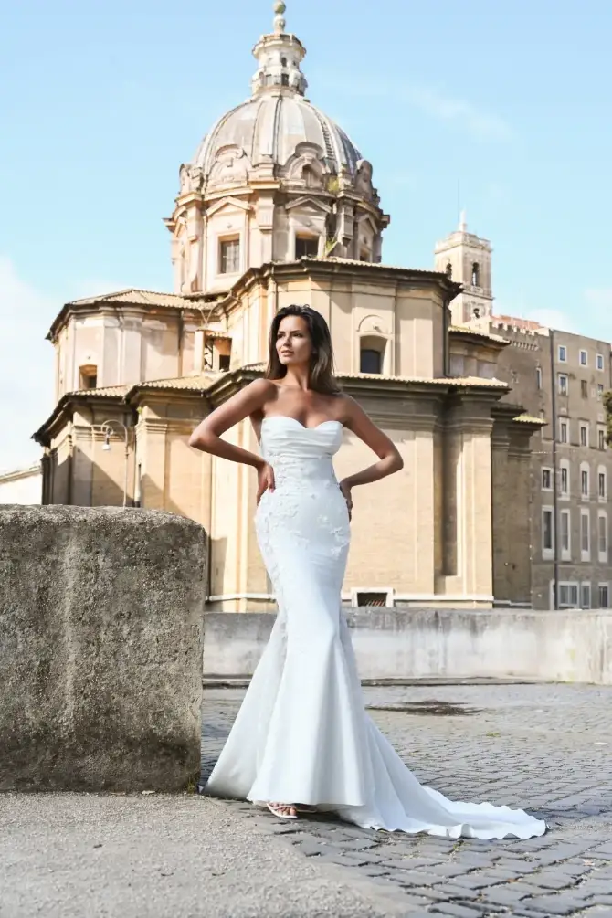 model is wearing a strapless fit and flare bridal gown