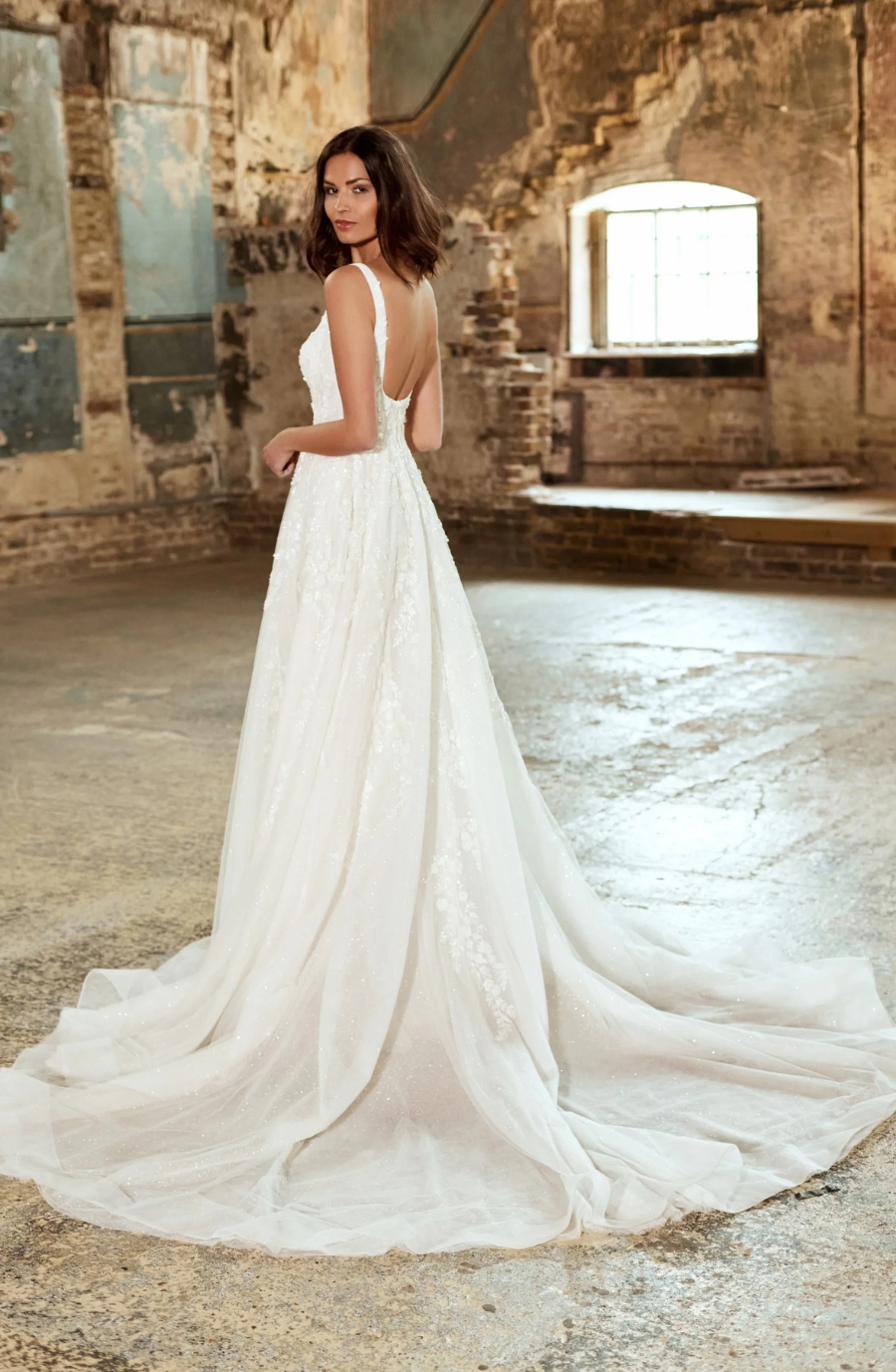 model is wearing a minimalist sleeveless a-line wedding dress